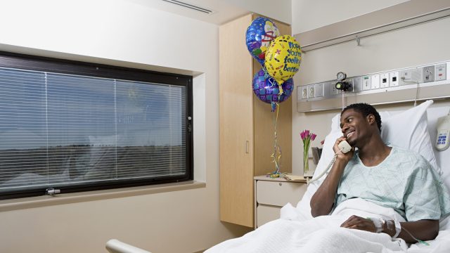 Patient on telephone in hospital bed